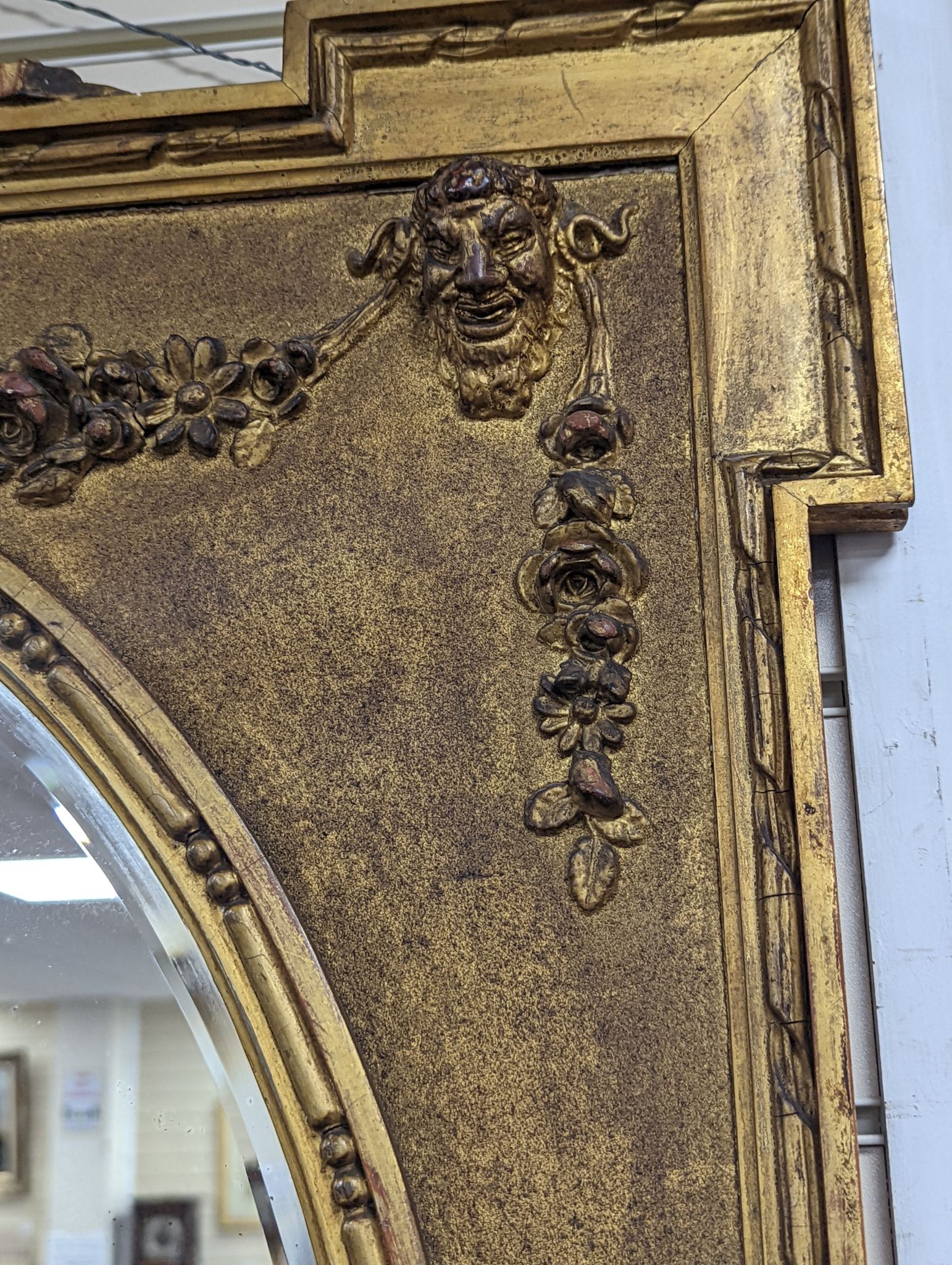 A Victorian style rectangular giltwood and gesso wall mirror, floral swag to top, with oval plate, width 70cm, height 92cm